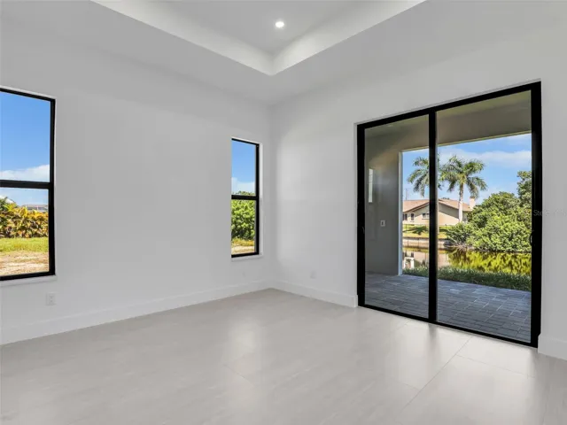 Master Bedroom with slider that goes out to the open lanai and has water views