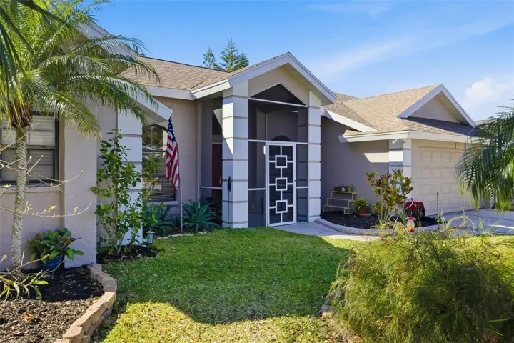 Welcoming front entry with screened porch and double doors—classic Florida design in a quiet Sarasota neighborhood just minutes to UTC and I-75.