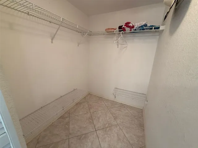 Primary bedroom walk in closet