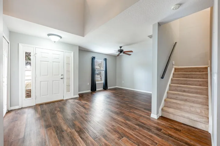 A light, bright foyer welcomes you home - opening to a flexible formal living or dining space.