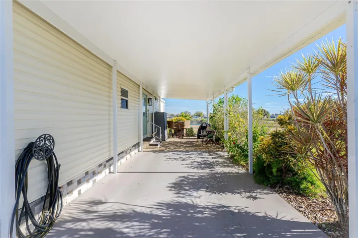 Carport built to current Codes in 2024.  Looks like 2 vehicles can park here, plus there is a generous driveway.Hmm what about storing your boat under here?