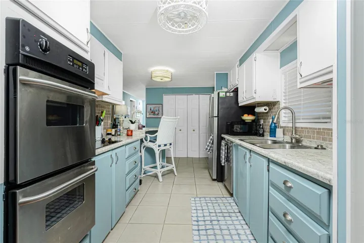 Kitchen has a double oven, cooktop, Stainless Steel appliances, cabinets upgrade and Decorative backsplash