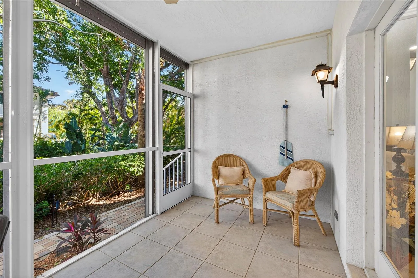 Screened enclosure with motorized storm shutters.