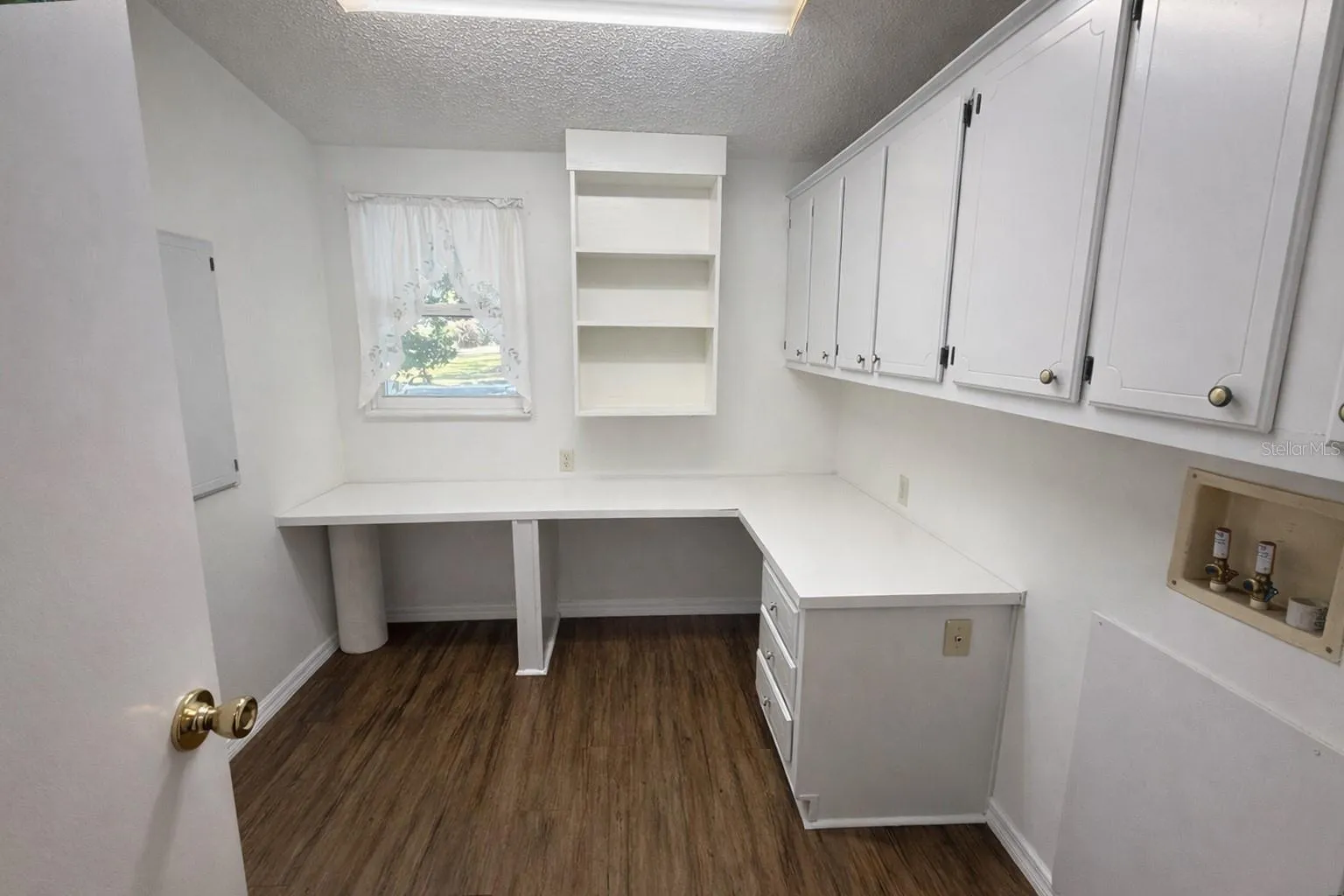 Inside laundry room with tons of storage and built-ins