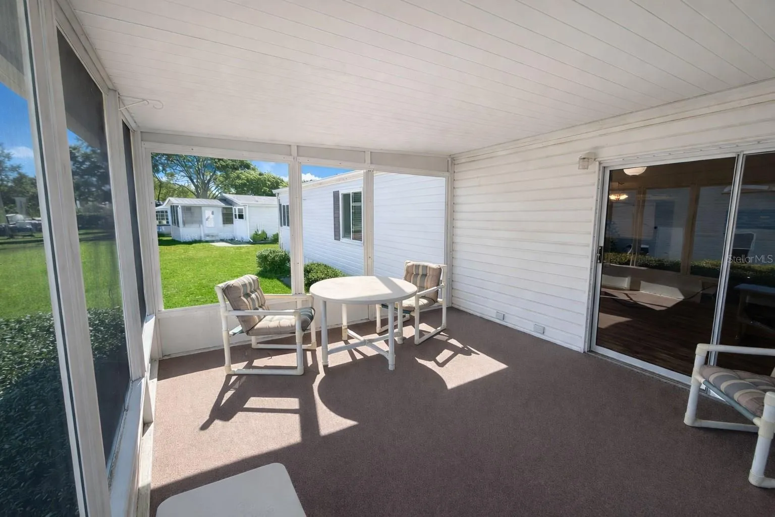 Lanai with backyard view and sliders to living room