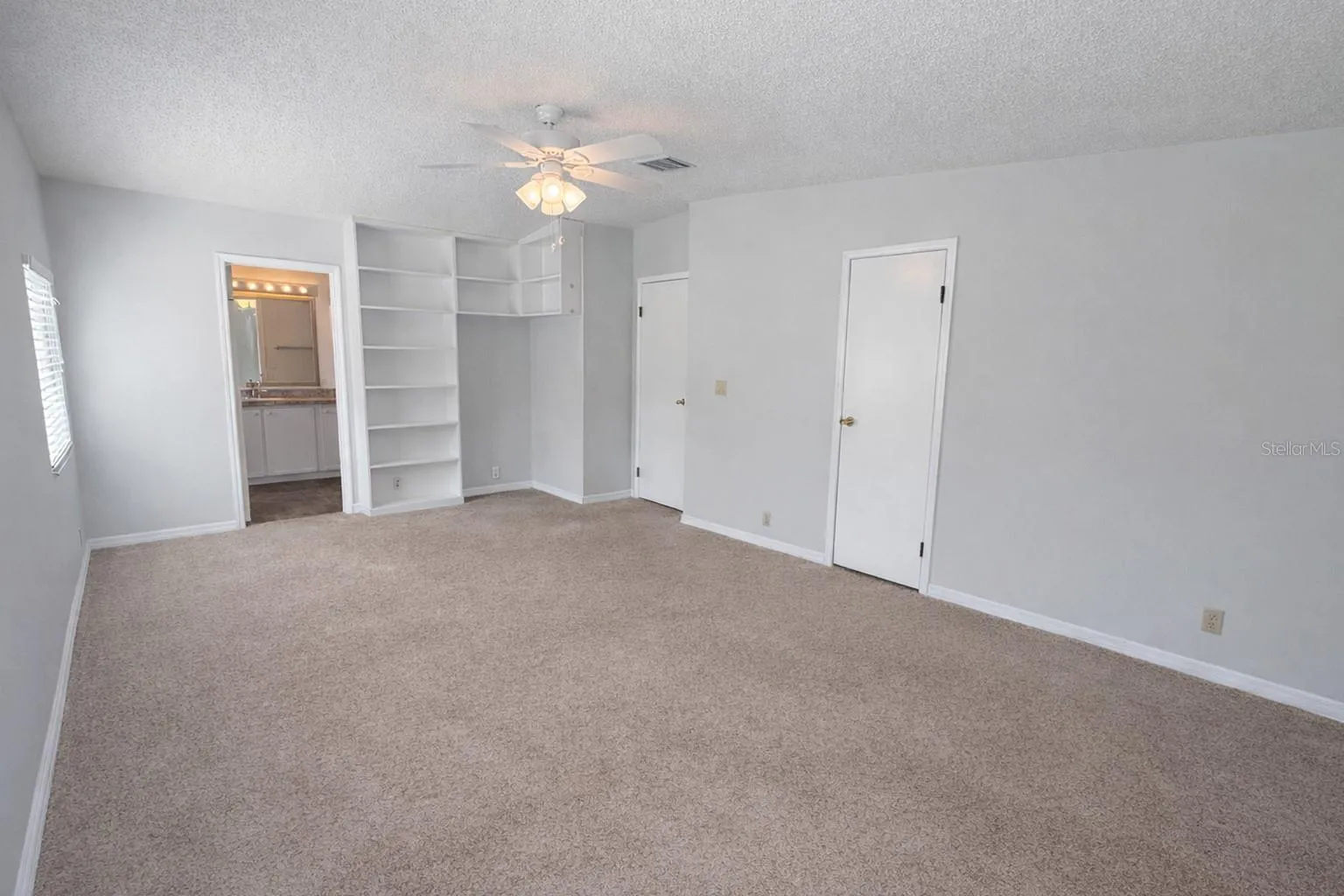 Freshly painted master bedroom with walk-in closet and built-ins