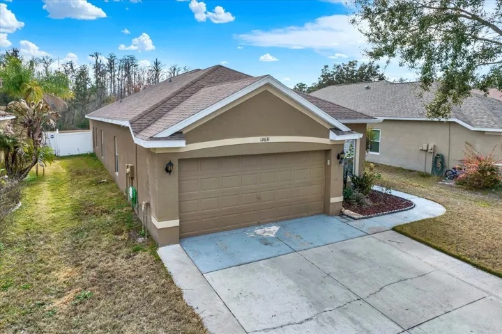 Front exterior of 12631 Chenwood Ave in gated community
