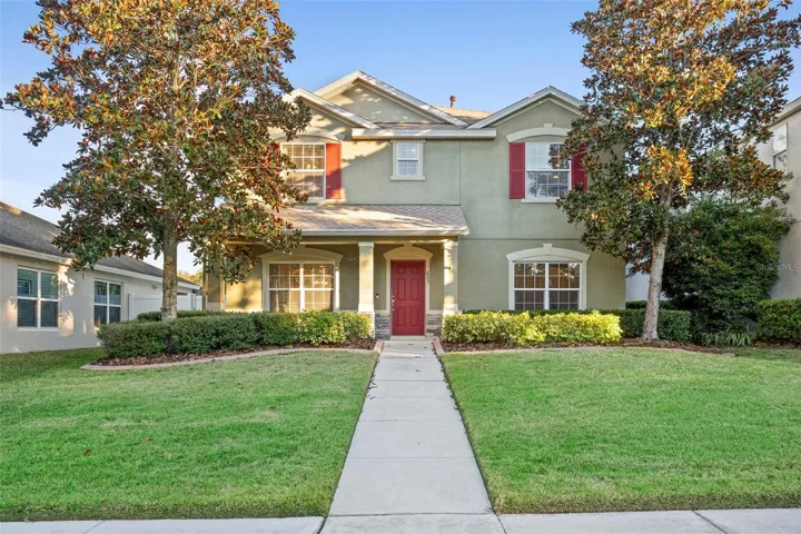 Front Exterior – A welcoming two-story exterior with a covered front porch, manicured lawn, and mature landscaping that adds curb appeal. Symmetrical windows, decorative shutters, and a defined walkway create a polished and inviting first impression.