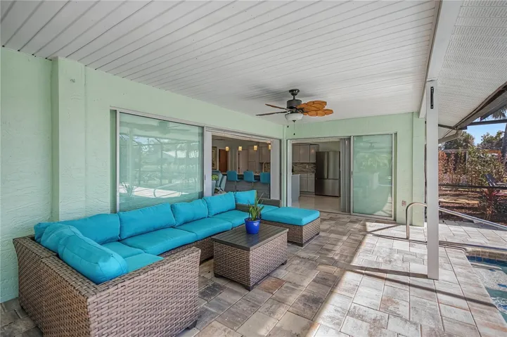 Covered patio featuring Spacious covered patio on pool deck with outdoor kitchen
