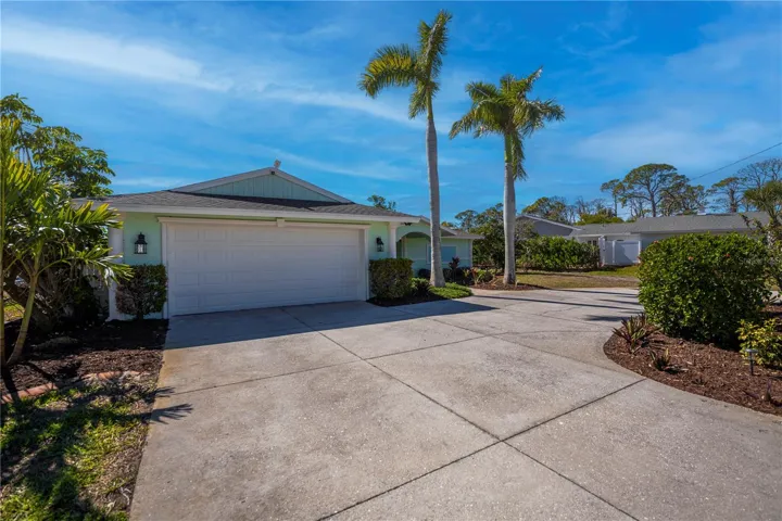 Front of home featuring garage and large circular driveway