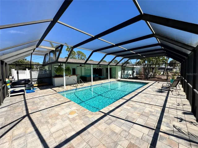 Large pool and deck under massive lanai