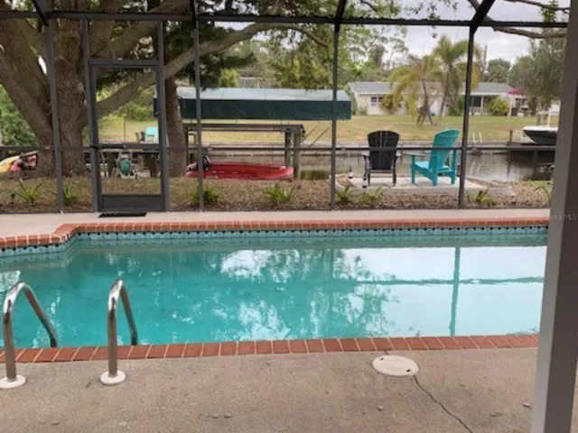 Pool with view of dock and canal
