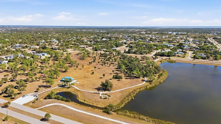 AERIAL VIEW OF PARK AND LAKE- BLUE ROOF STRUCTURE (LARGE GAZEBO) JUST RECENTLY COMPLETED, ACTIVITIES ARE HELD HERE