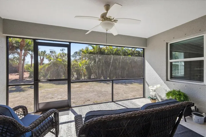 COVERED AND SCREENED LANAI VIEW FROM SLIDERS IN GREAT ROOM