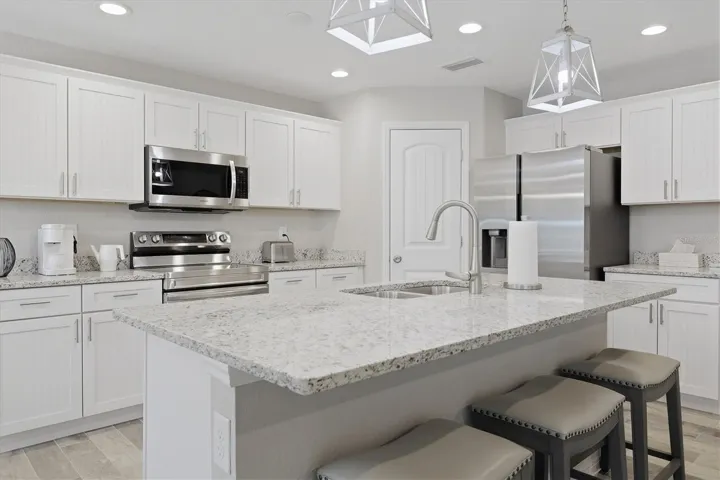 KITCHEN - ISLAND WHERE SPLIT SINK IS AND BREAFKAST BAR DOOR TO REAR RIGHT IS PANTRY
