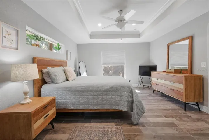 PRIMARY BEDROOM AGAIN WITH TRAY CEILING BOASTING CROWN MOLDING