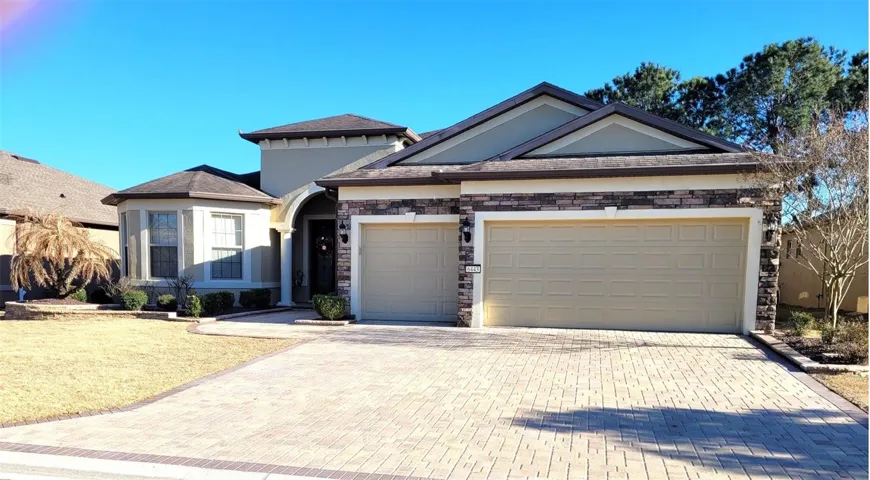 Enhanced roofline with extended garage, stone work accents, extended paver entrance and driveway. Complemented by landscaping pavers.