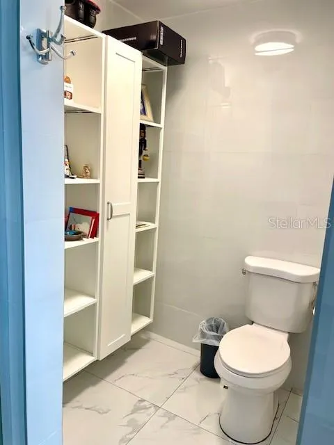 guest bathroom including cabinet