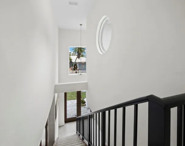 Head up the stairs to 2 more bedrooms and a 2nd level lanai overlooking the gorgeous backyard