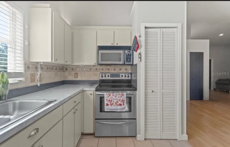 Open Kitchen with newer stainless steel appliances.