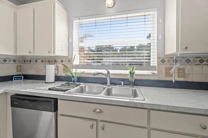 Open Kitchen with newer stainless steel appliances.