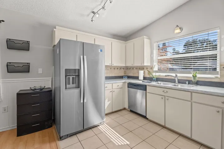 Open Kitchen with newer stainless steel appliances.