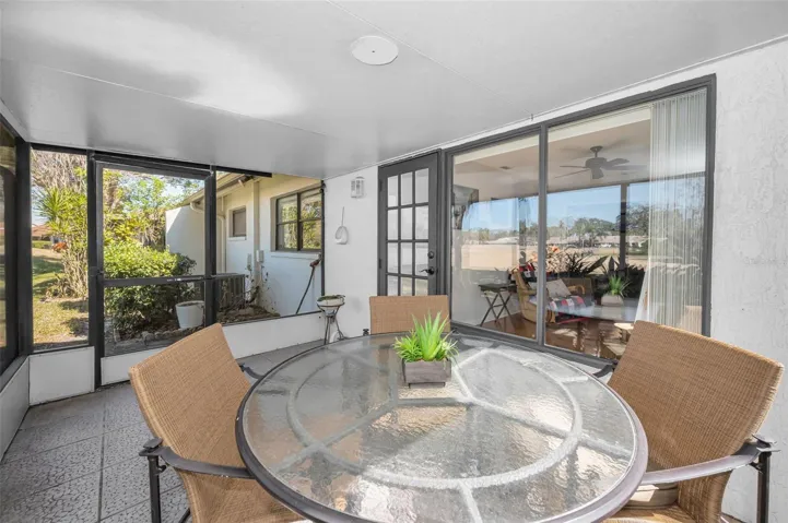 Enclosed porch overlooking pond and golf course