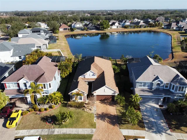 Aerial view of home with rear pond