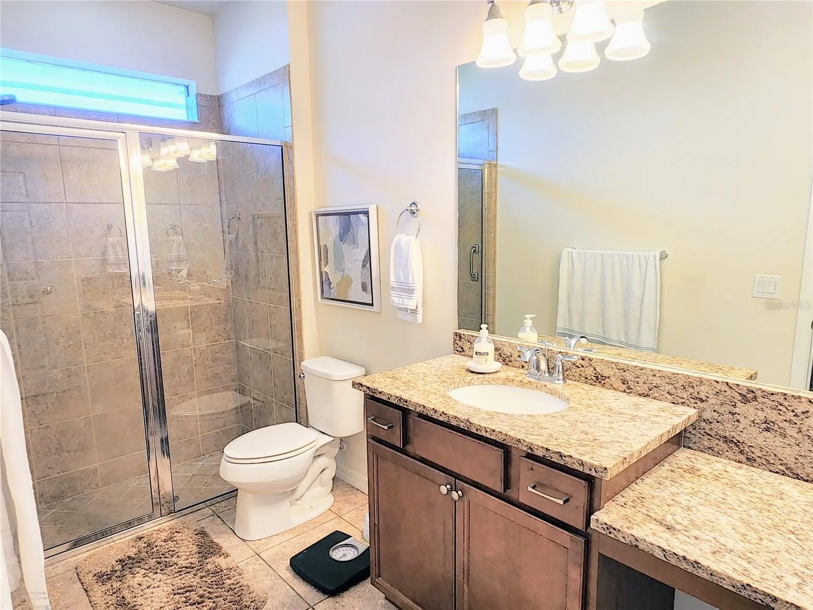 master bath has walk in shower with a window above for light