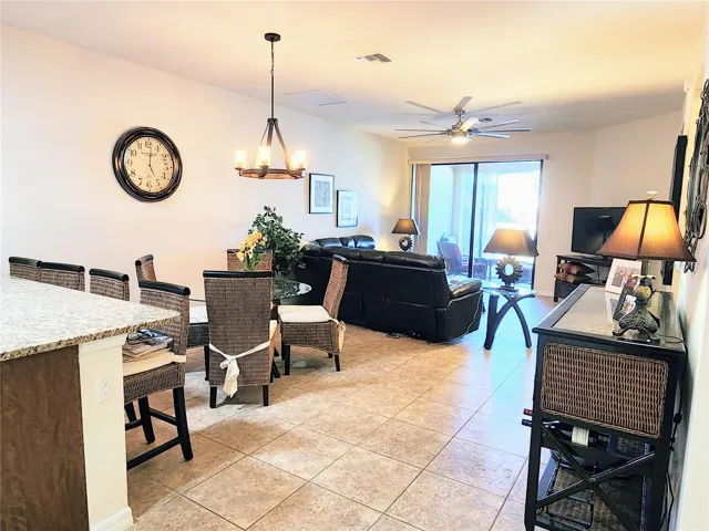 The kitchen bar has 4 nice stools, a nice chandelier over the glass top dining room table and a large ceiling fan in the living room