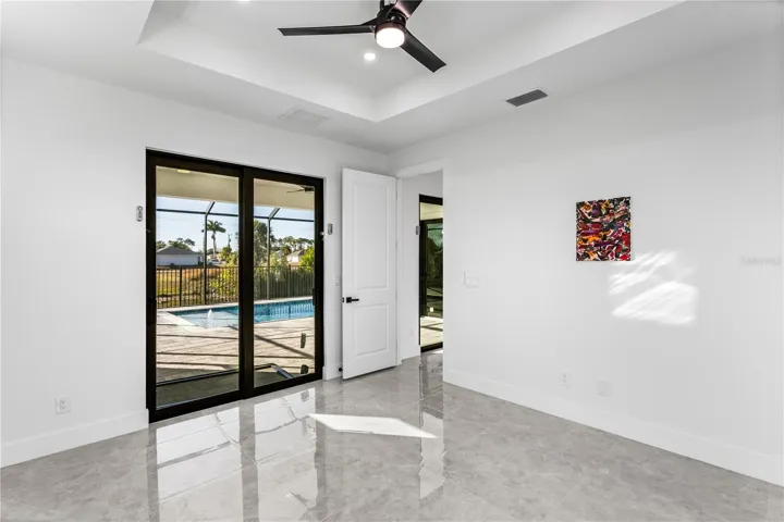 The primary suite offers lanai access, his-and-her walk-in closets, and a spa-style bath with dual sinks, soaking tub, and walk-in shower.