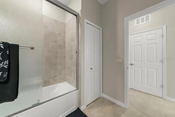Guest bathroom cont. with linen closet.