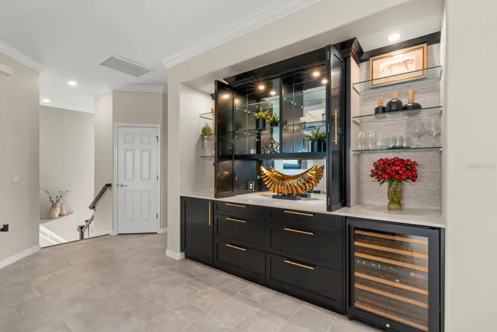 Custom dry bar with cabinets open.