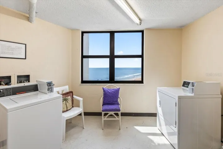 Bright and clean on-site laundry room featuring commercial-grade Whirlpool washers and dryers, ample folding space, and easy-access layout for residents’ convenience.