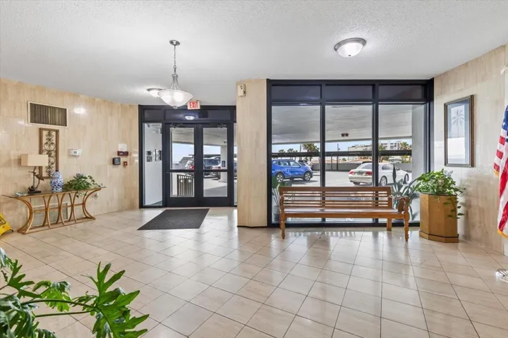 Bright, welcoming lobby with secure entry and covered parking access. Clean tile floors, natural light, and a comfortable seating area create a polished first impression for residents and guests alike.