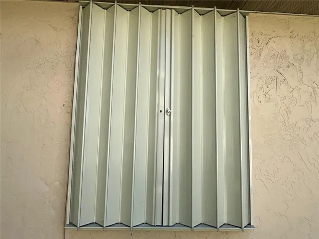 Accordion shutters on all windows and openings