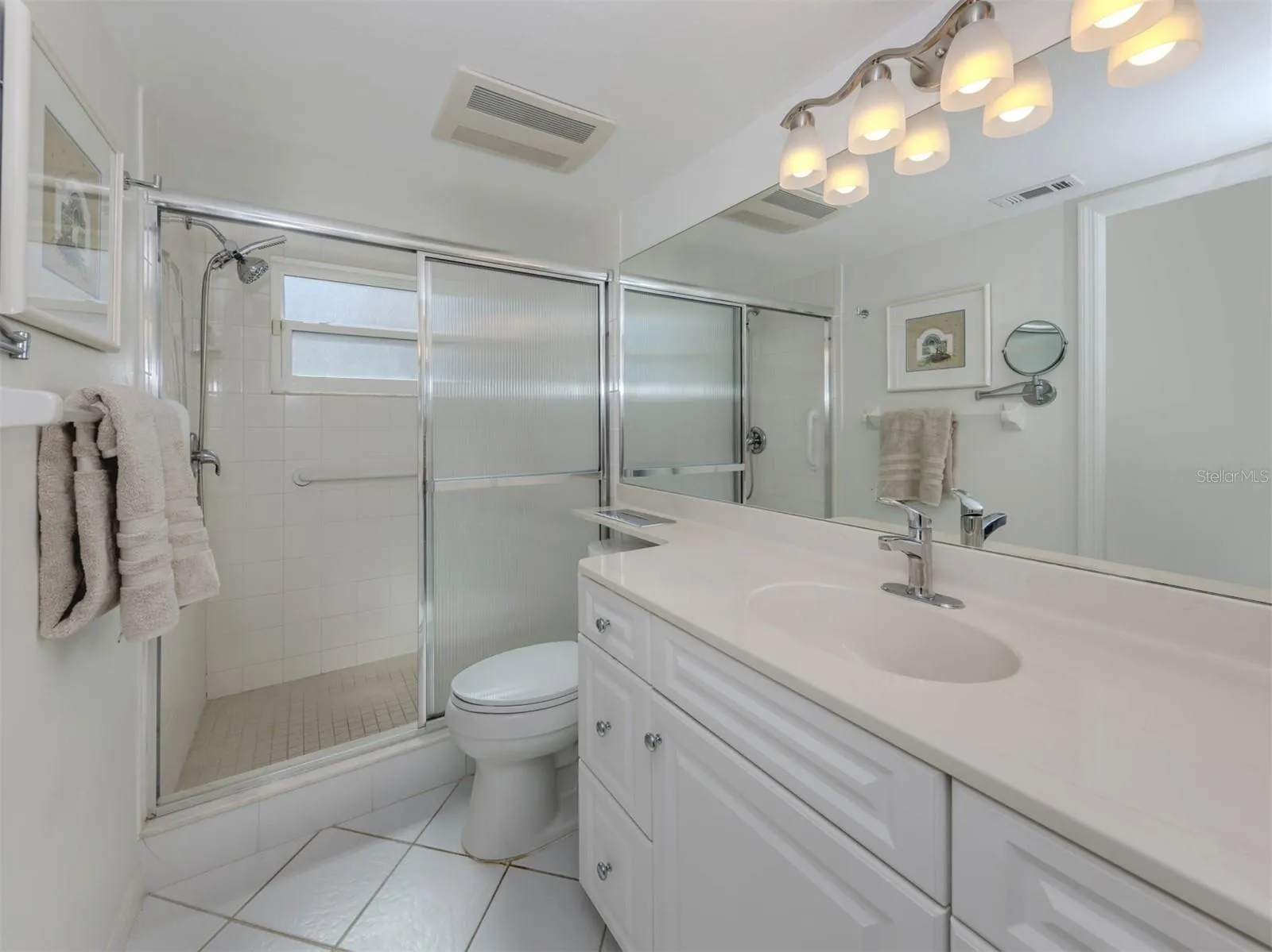 The master ensuite includes a large walk in shower and high top cabinetry