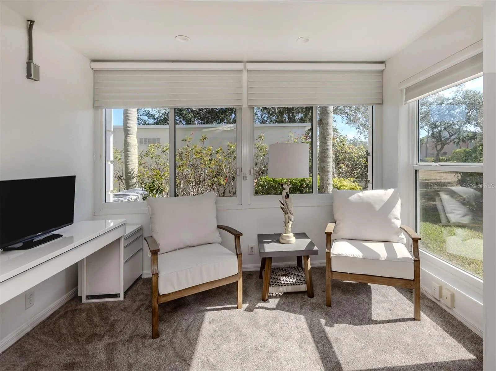 The master sunroom is sun filled and the perfect spot for a morning coffee or tea