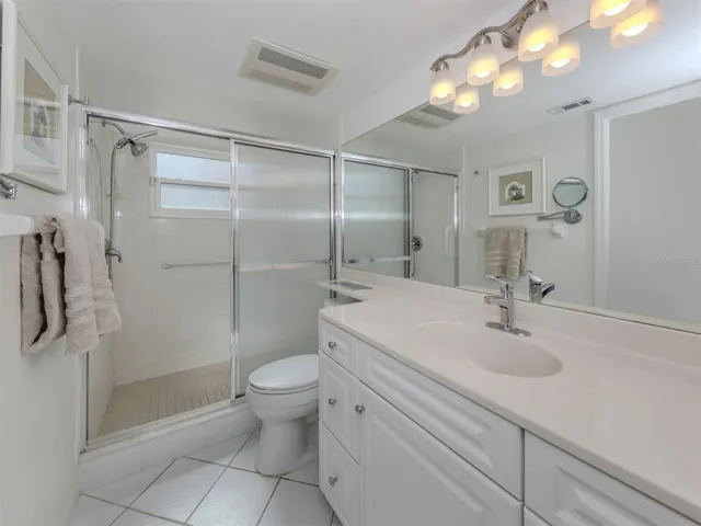 The master ensuite includes a large walk in shower and high top cabinetry