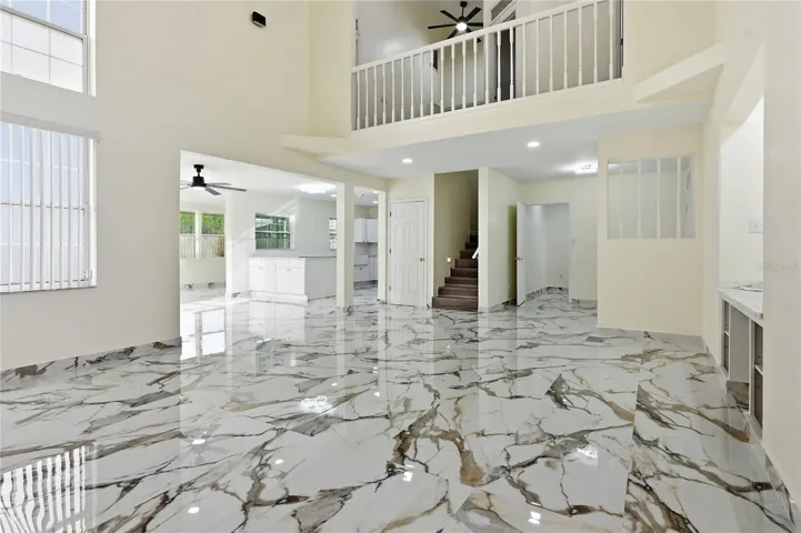 Family room: view of kitchen, entryway, and upstairs