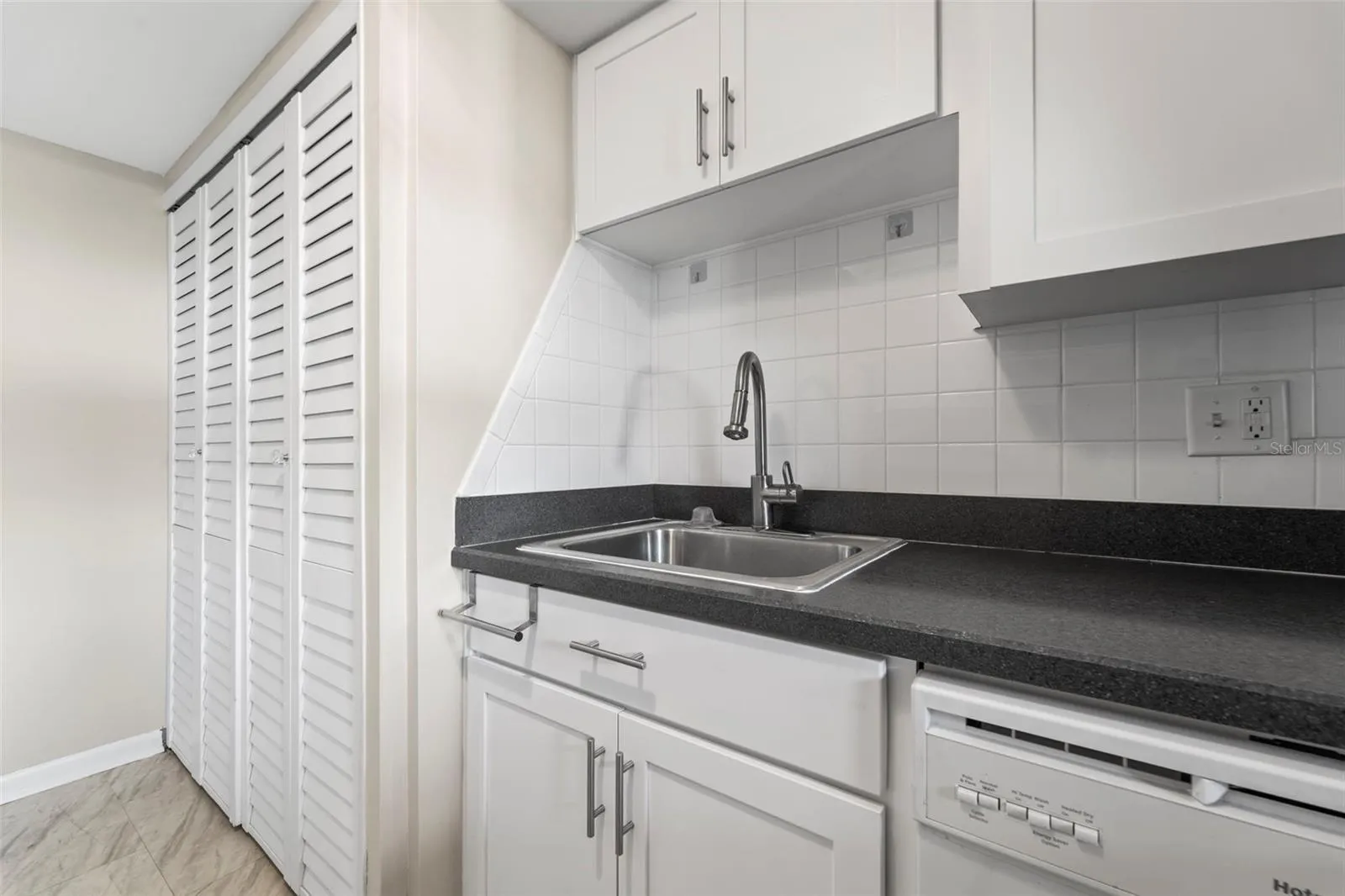 Kitchen with nice white cabinets...washer and dryer are in the cabinet on the left of the photo