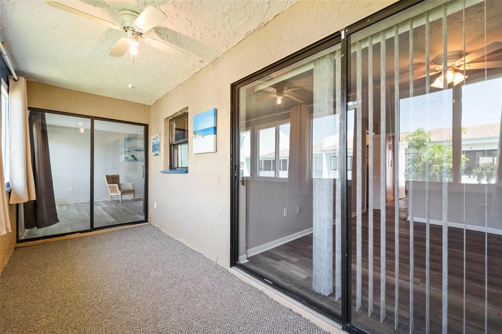 In the corner of the back porch facing the living roon on the left and master bedroom sliders on the right..