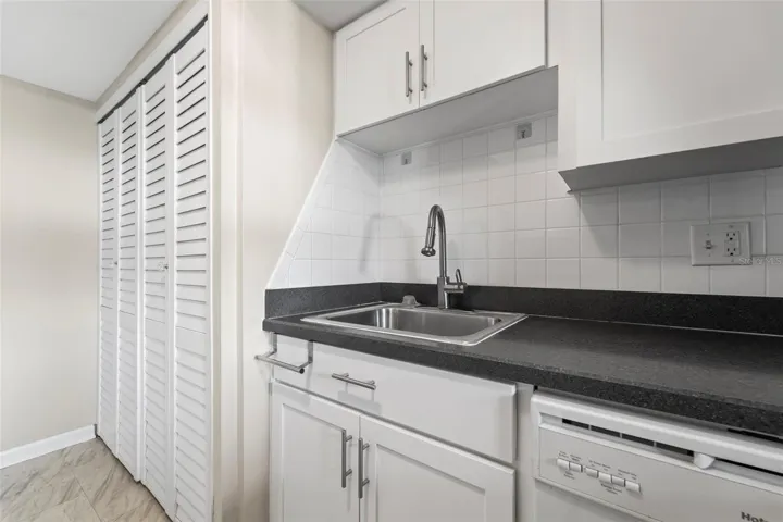 Kitchen with nice white cabinets...washer and dryer are in the cabinet on the left of the photo