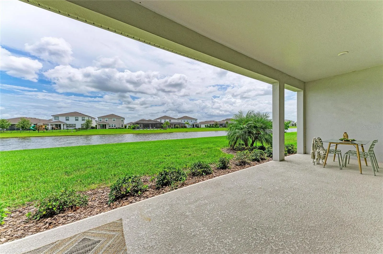 Beautiful rear elevation showcasing seamless indoor-outdoor living and waterfront setting