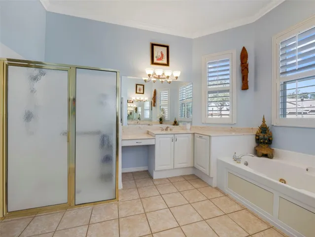 A spa-inspired en suite bath boasts a soaking garden tub, two separate oversized vanities, a step-in shower, and a private water closet.