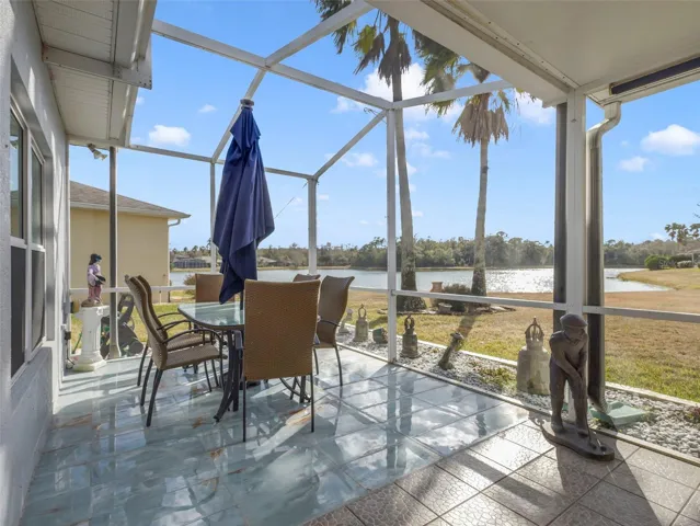 Step outside to the EXPANSIVE SCREENED and ENCLOSED REAR PATIO, where breathtaking pond views set the stage for morning coffee or evening sunsets.
