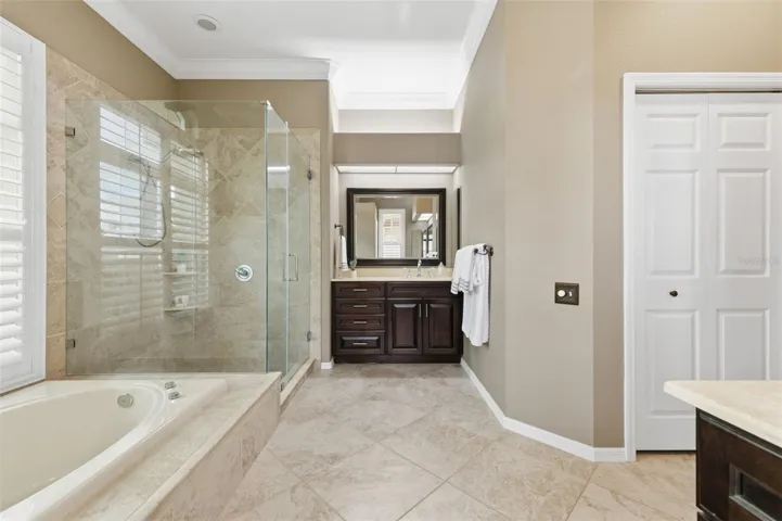 Remodeled primary suite with travertine counter tops.