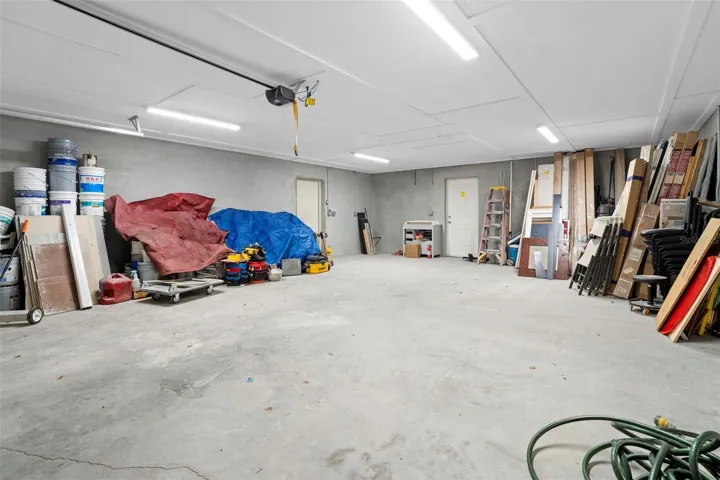 Garage 1-1, door on left leads to BR 5, door on right leads to backyard (outside of back patio/deck screen enclosure).