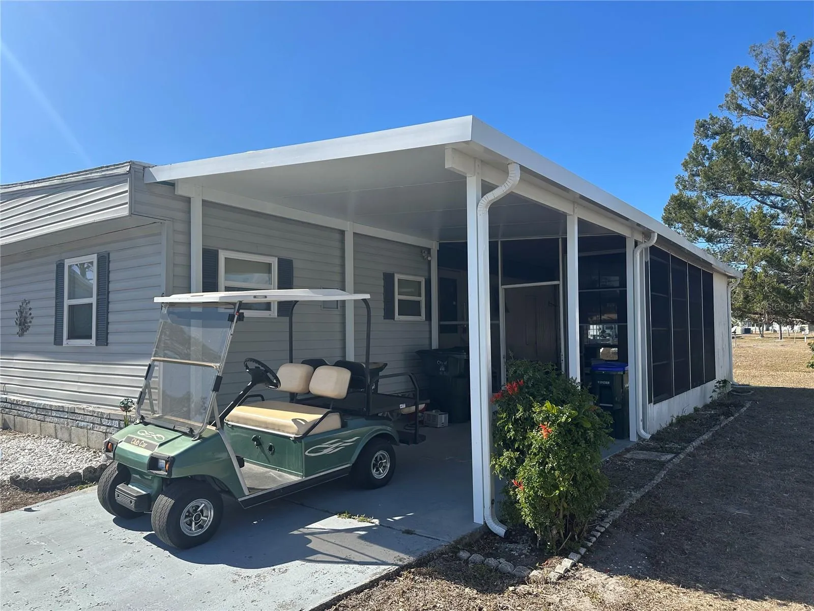 Right side of the house with carport and covered lanai