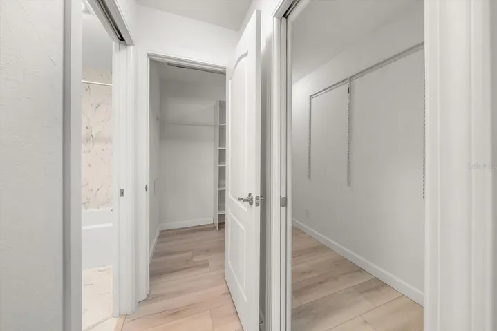 large primary walk in closet with 2 doors for easy access